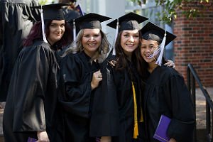첥Ӱstudents in cap and gown standing in line at graduation